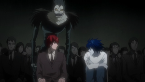 A tense scene from Death Note showing Light Yagami and the detective L sitting side-by-side, with Ryuk visible only to Light.