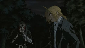 Edward Elric in a serious confrontation with an enemy in a dark forest in Fullmetal Alchemist Brotherhood.