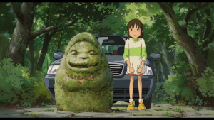 Chihiro looking uncertain next to a mossy stone statue near her parents' car at the entrance to the spirit world in Spirited Away.